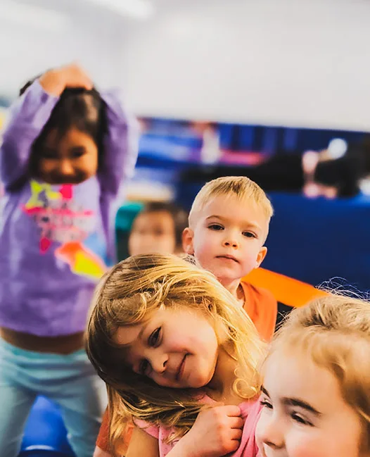 Kids smiling together at a PEGA Parents' Night Out